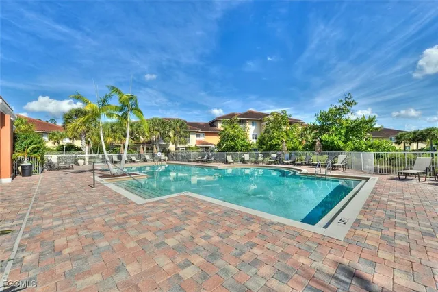 a view of swimming pool with outdoor seating and plants