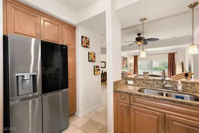 a kitchen with stainless steel appliances granite countertop a refrigerator and a sink