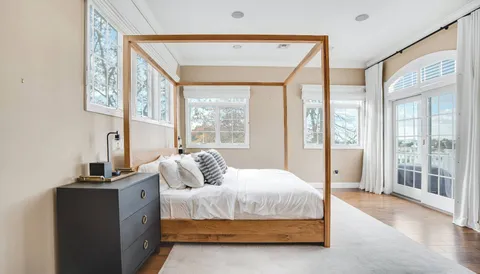 a bedroom with a large bed and a large window