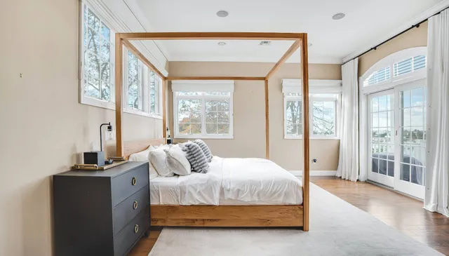 a bedroom with a large bed and a large window