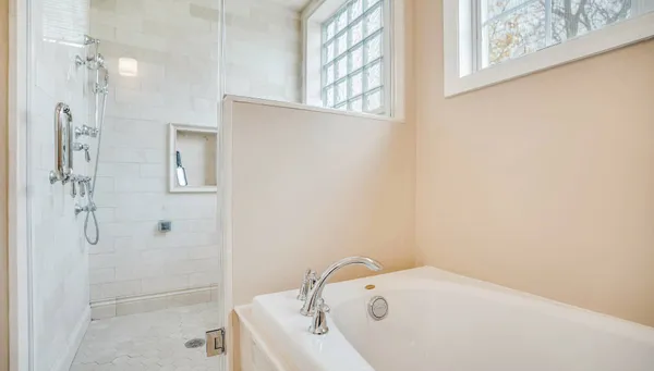 a bathroom with a tub and shower