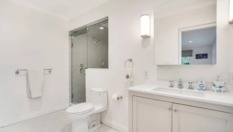a bathroom with a sink toilet and shower