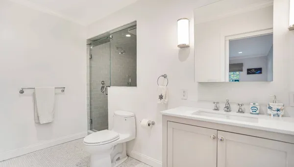 a bathroom with a sink toilet and shower