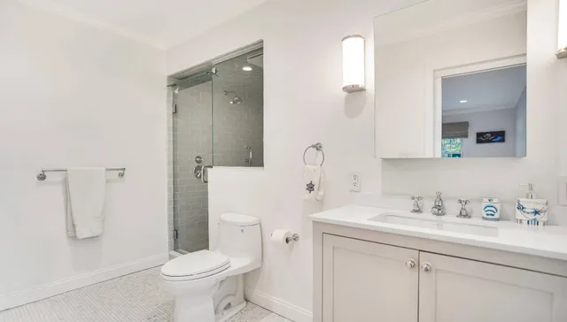 a bathroom with a sink toilet and shower