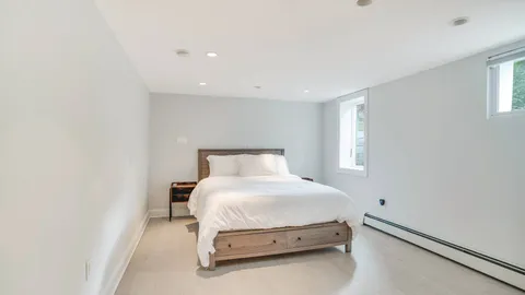 a room with a bed and a night stand