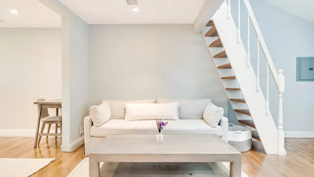 a white couch sitting next to a white cabinet