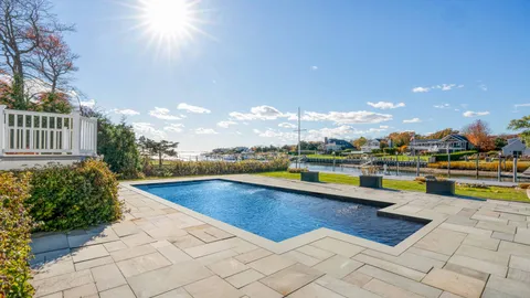 a view of swimming pool with outdoor seating and plants