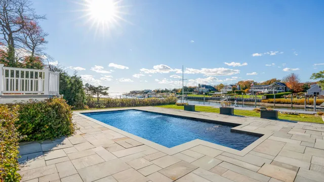 a view of swimming pool with outdoor seating and plants