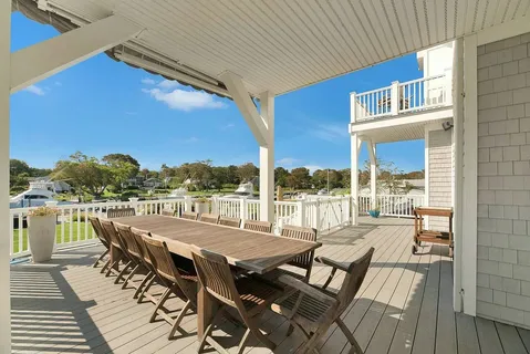 a view of a outdoor dining space with furniture and city view