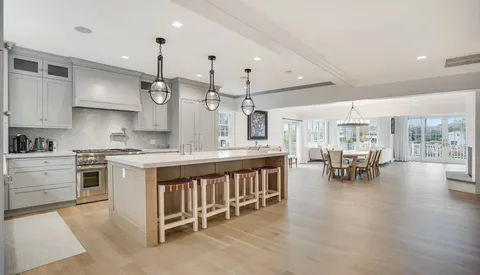 a kitchen with counter and chairs in it