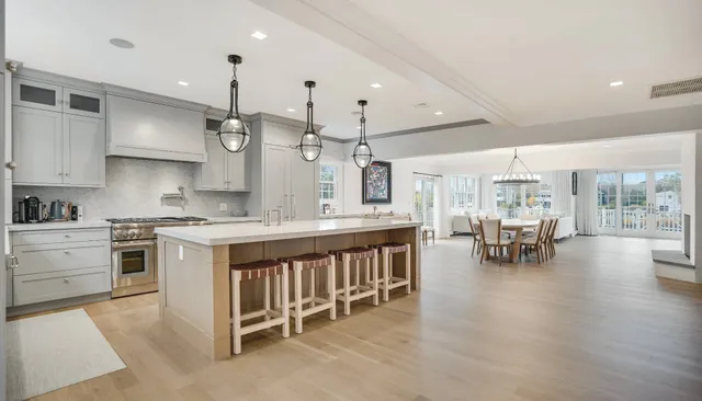 a kitchen with counter and chairs in it