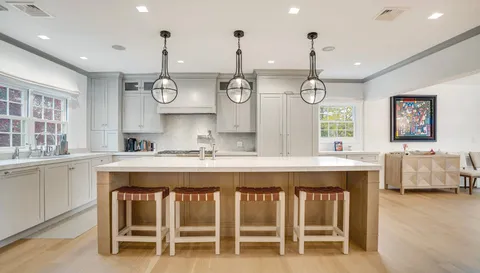 a large kitchen with a table and chairs