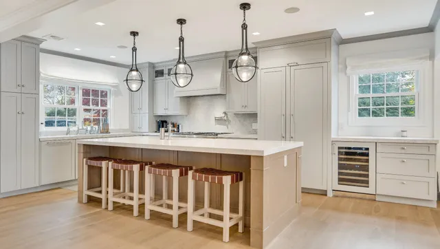 a kitchen with a large island and windows