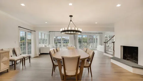 a dining room with furniture window and wooden floor