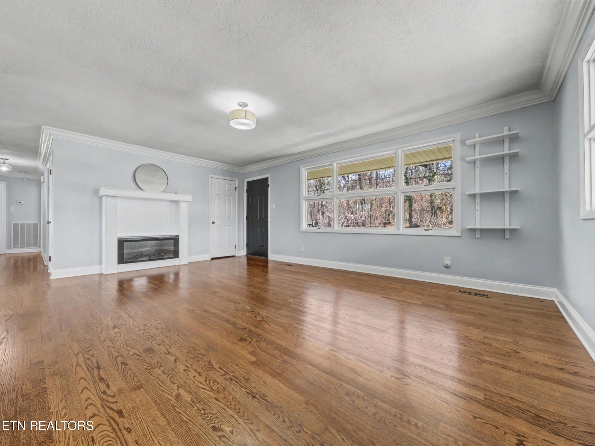 209 Wakefield Road Knoxville, TN 37922 - Photo 13 of 29 a view of an empty room with a window and wooden floor