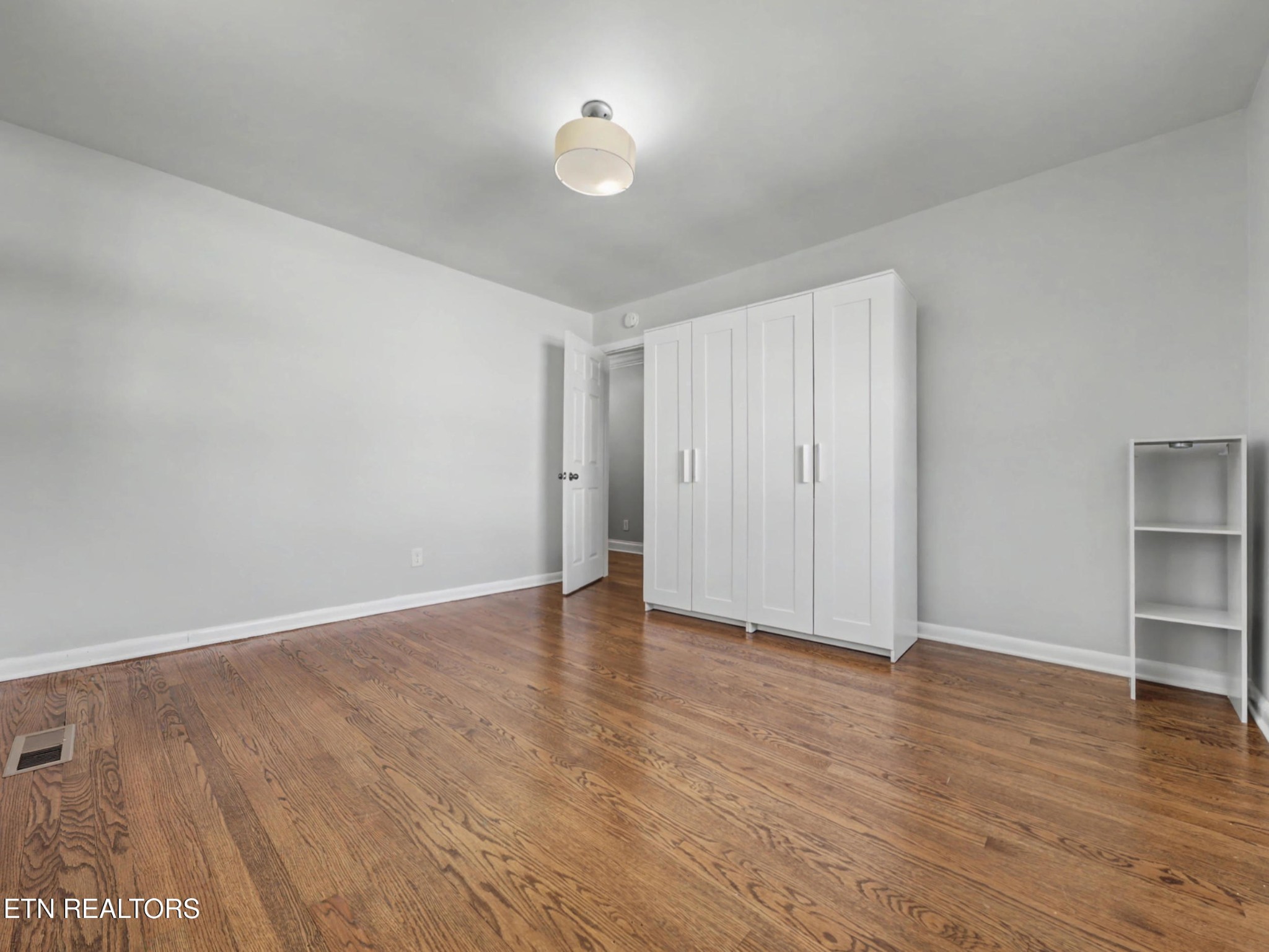 209 Wakefield Road Knoxville, TN 37922 - Photo 18 of 29 a view of an empty room with wooden floor closet and a window