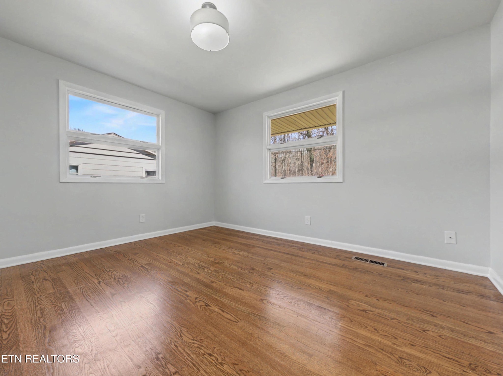 209 Wakefield Road Knoxville, TN 37922 - Photo 19 of 29 an empty room with wooden floor and windows