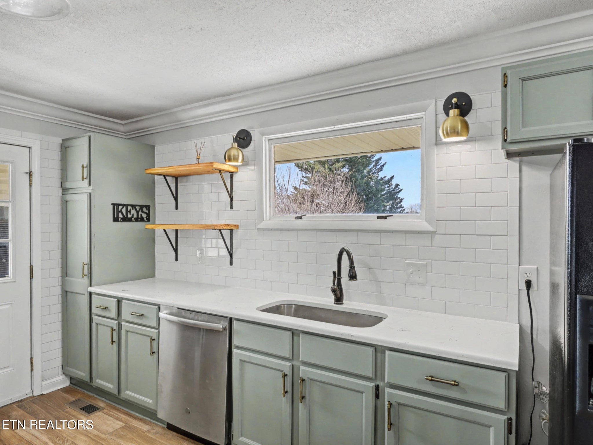 209 Wakefield Road Knoxville, TN 37922 - Photo 7 of 29 a kitchen with a sink and a refrigerator