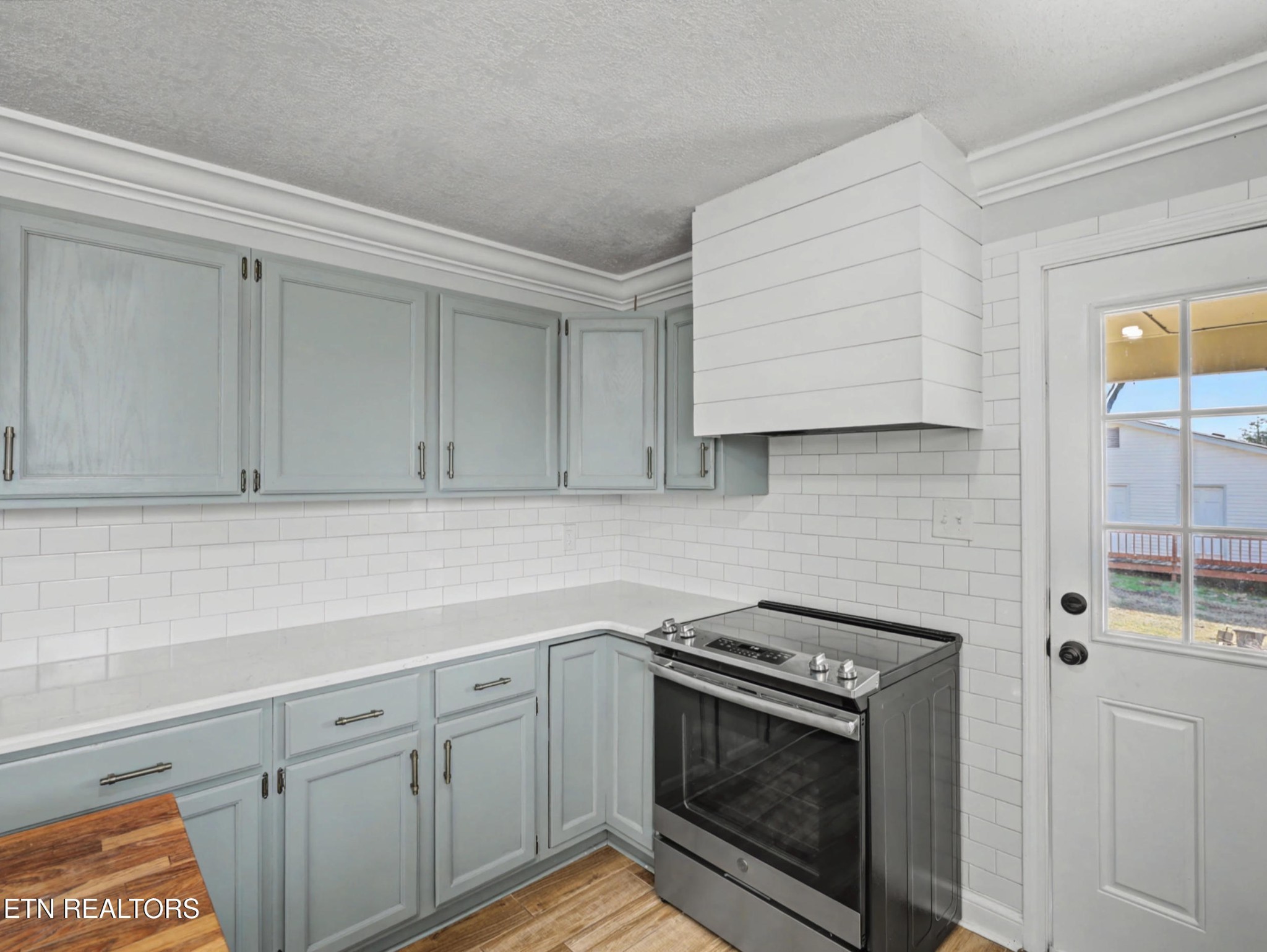 209 Wakefield Road Knoxville, TN 37922 - Photo 8 of 29 a kitchen with stainless steel appliances white cabinets and a stove