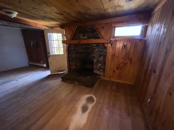 79 Station Road Barre, MA 01005 - Photo 9 of 13 wooden floor in an empty room with a fireplace