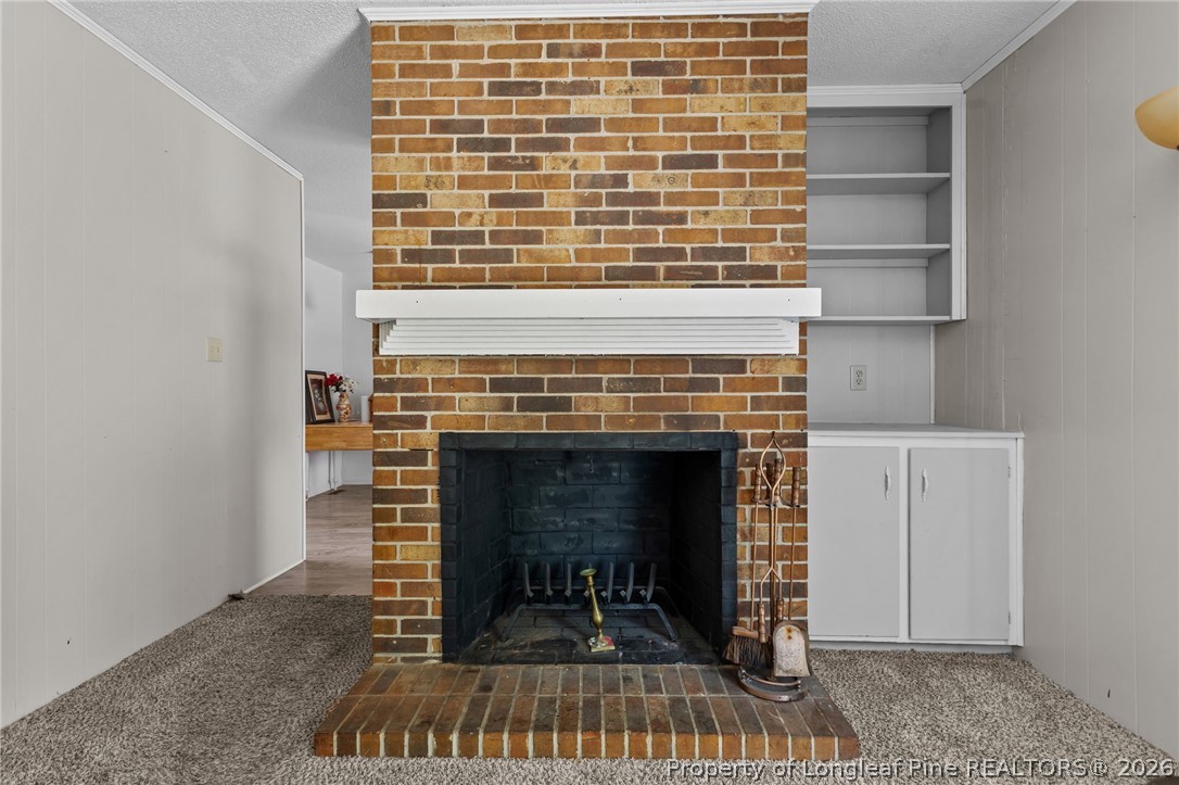 908 Ruton Court Fayetteville, NC 28303 - Photo 16 of 29 a living room with a fireplace and a table
