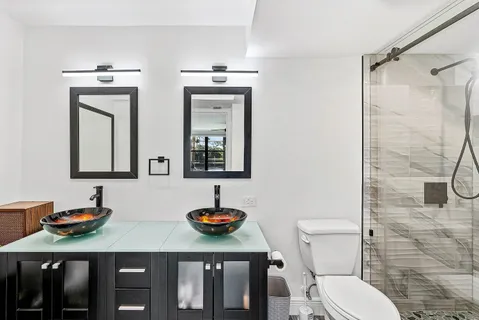 a bathroom with a toilet a sink and mirror