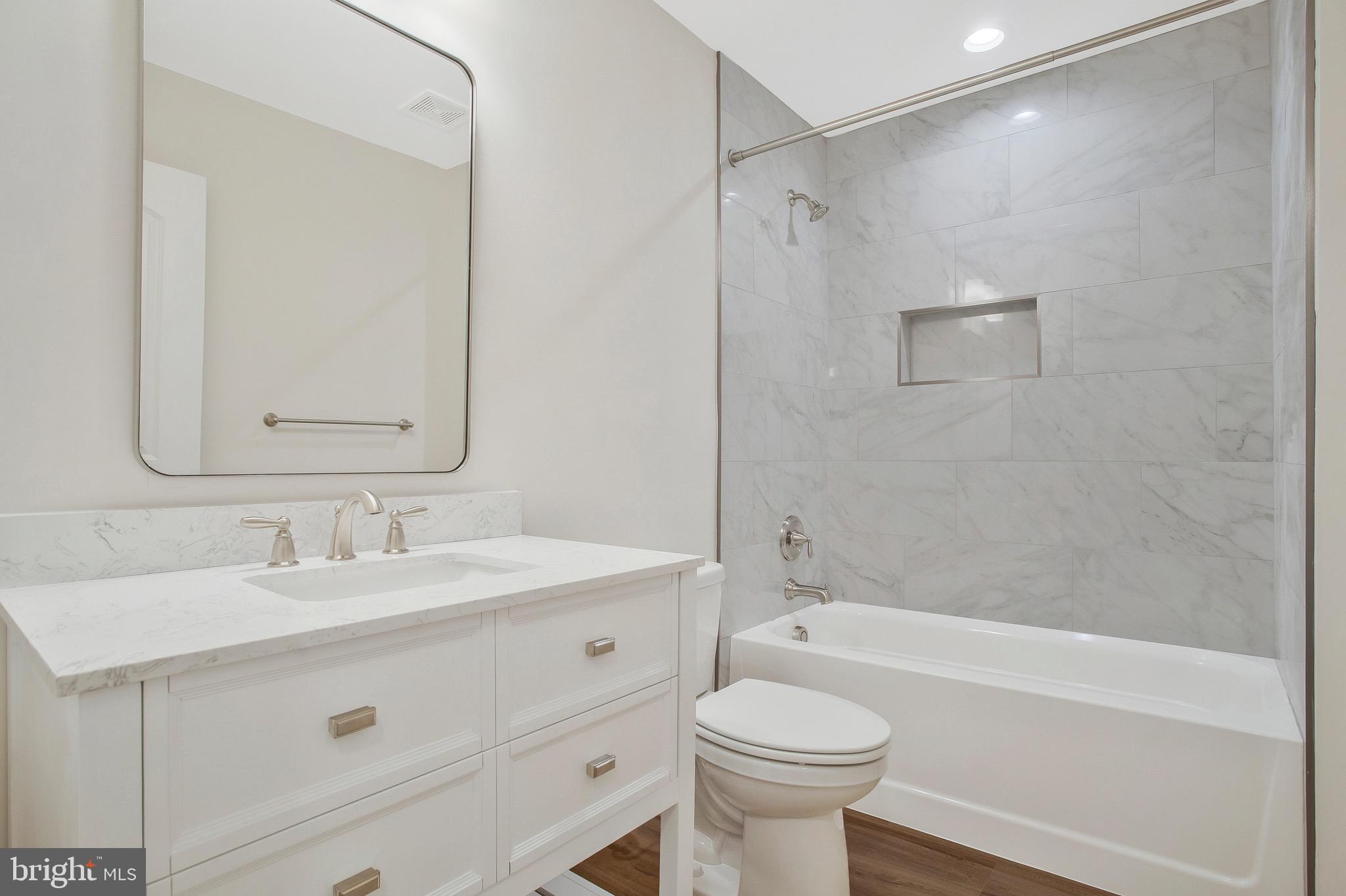 11541 Bootstrap Trail Lusby, MD 20657 - Photo 19 of 24 a bathroom with a sink a toilet and a bathtub