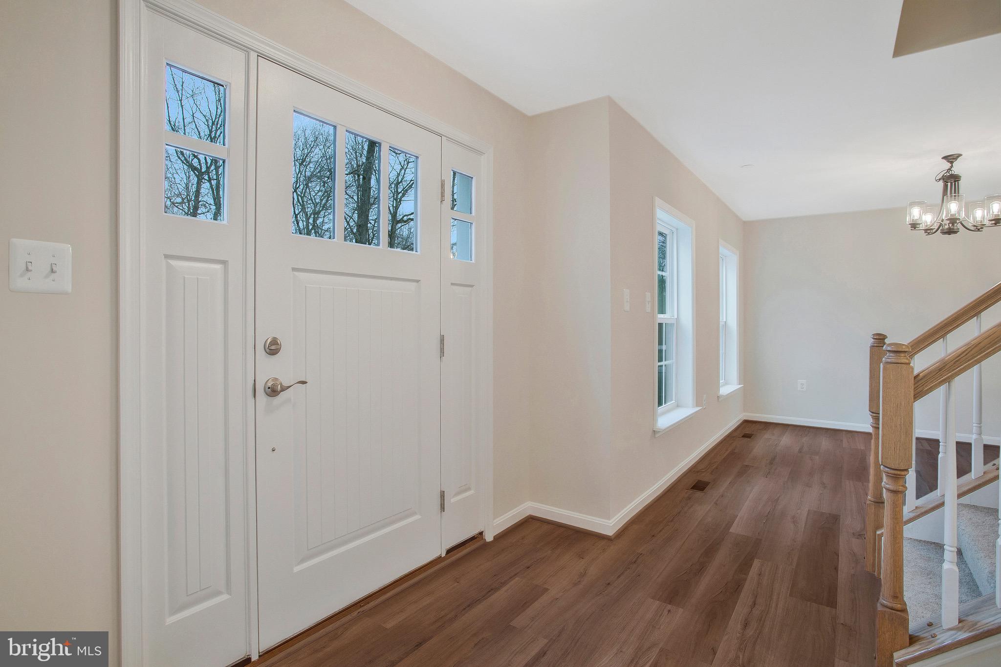 11541 Bootstrap Trail Lusby, MD 20657 - Photo 2 of 24 a view of an empty room with wooden floor and a window