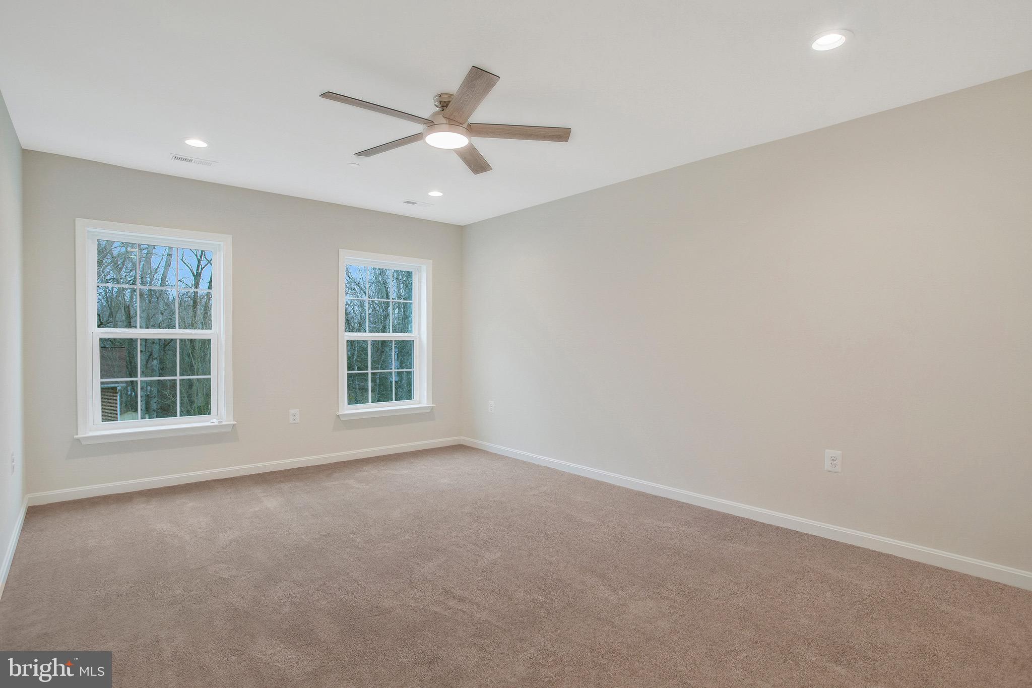 11541 Bootstrap Trail Lusby, MD 20657 - Photo 21 of 24 an empty room with windows and fan