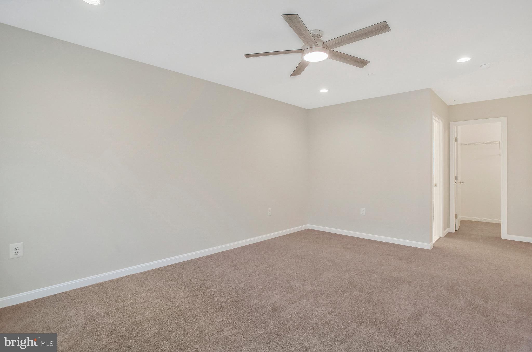 11541 Bootstrap Trail Lusby, MD 20657 - Photo 22 of 24 an empty room with a ceiling fan and a window