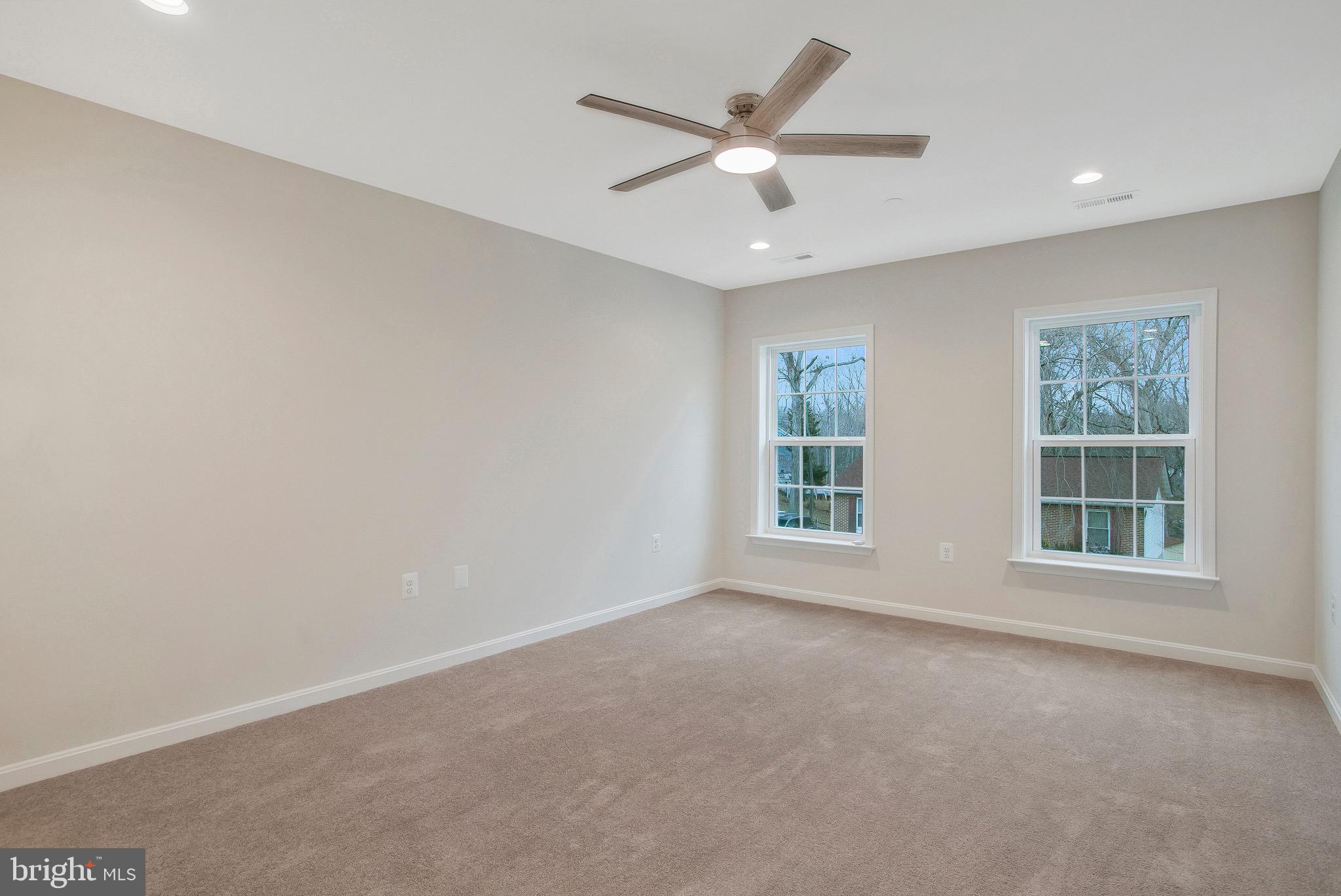 11541 Bootstrap Trail Lusby, MD 20657 - Photo 23 of 24 an empty room with a ceiling fan and windows