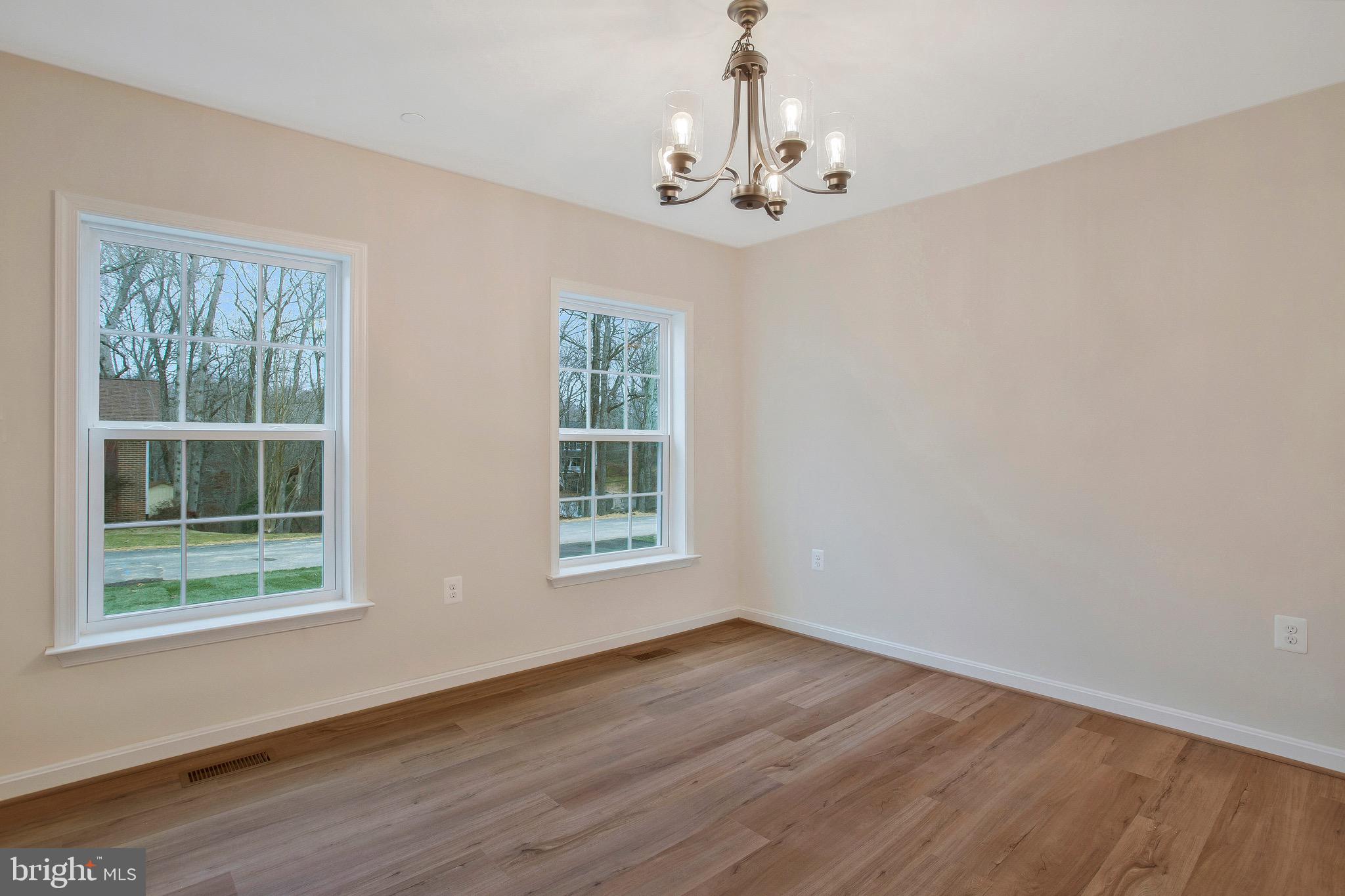 11541 Bootstrap Trail Lusby, MD 20657 - Photo 4 of 24 a view of empty room with wooden floor and fan