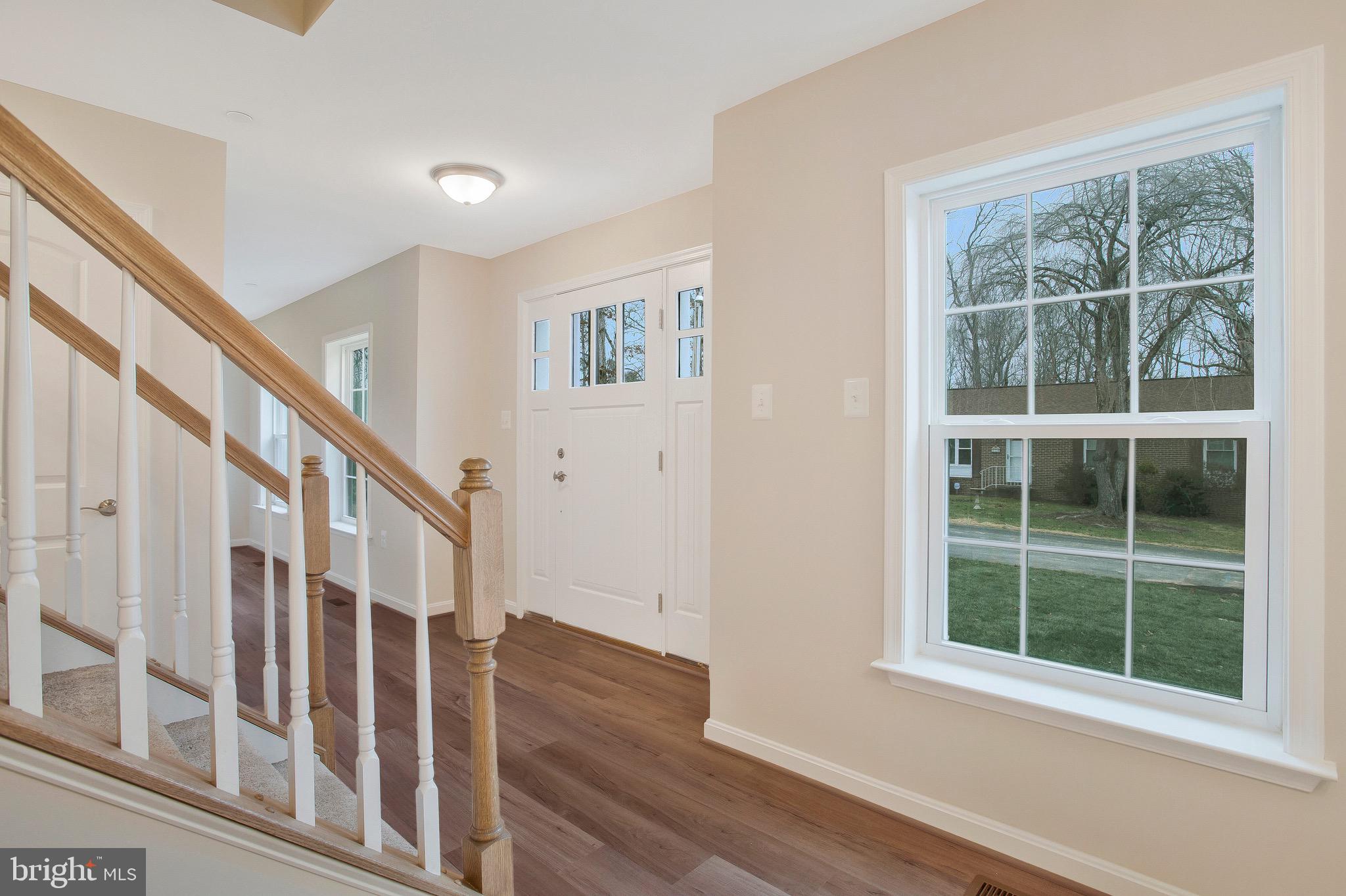 11541 Bootstrap Trail Lusby, MD 20657 - Photo 5 of 24 a view of staircase with window and wooden floor