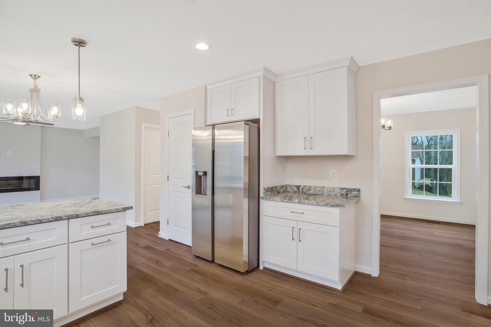 11541 Bootstrap Trail Lusby, MD 20657 - Photo 8 of 24 a kitchen with a refrigerator a sink and wooden floor