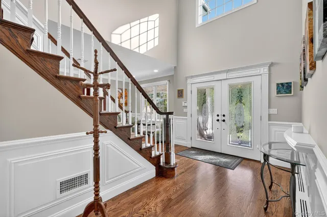 a view of entryway with wooden floor and stairs