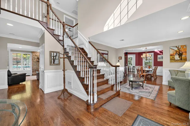 a view of entryway livingroom and hall with wooden floor