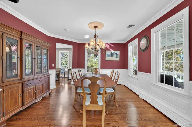 a view of a dining room with furniture windows and wooden floor