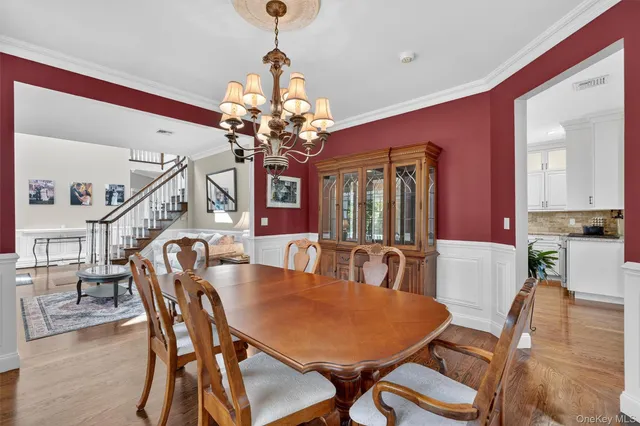 a view of a dining room with furniture and chandelier