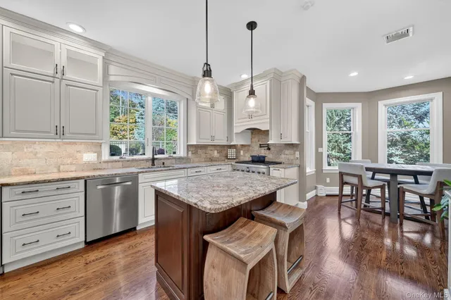 a kitchen with center island table and chairs