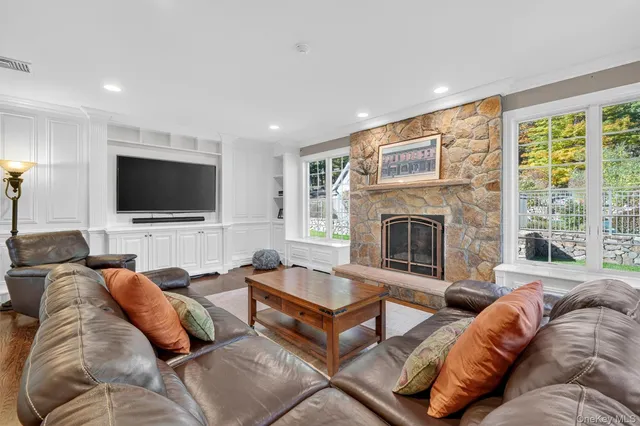 a living room with a couch a flat screen tv and a fireplace