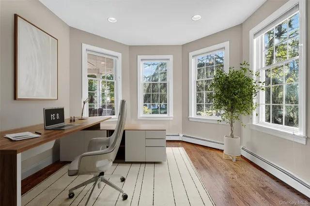 a view of a livingroom with workspace and a window