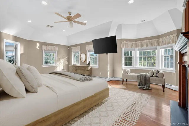 a bedroom with a bed and a large window