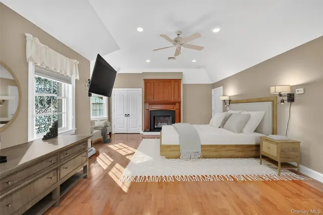 a spacious bedroom with a bed and a flat screen television