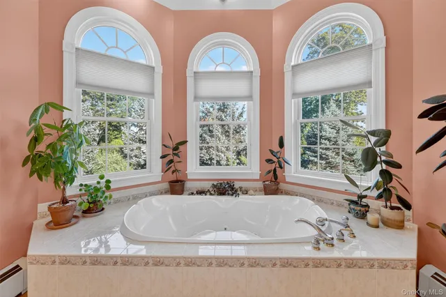 a white bath tub sitting next to a window