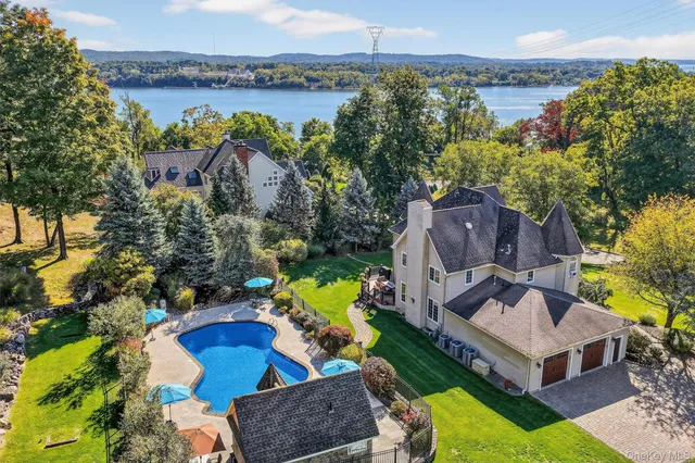 a view of a swimming pool with a patio and a garden
