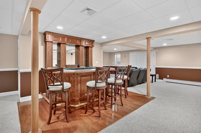 a view of a a dining room with furniture window and wooden floor