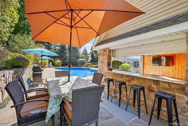 a view of a patio with table and chairs
