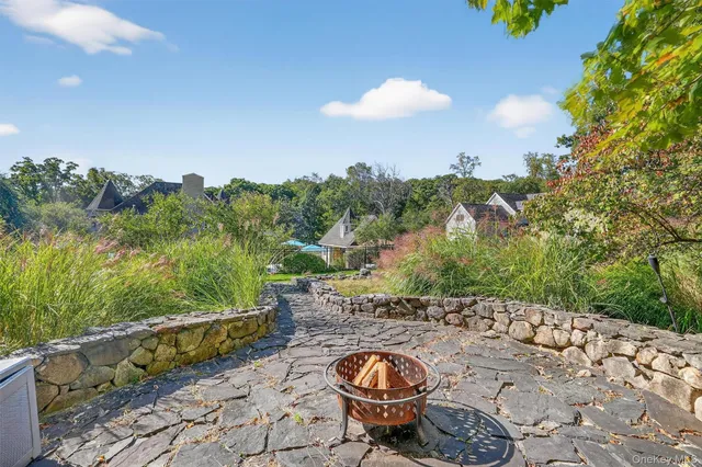 a backyard of a house with table and chairs