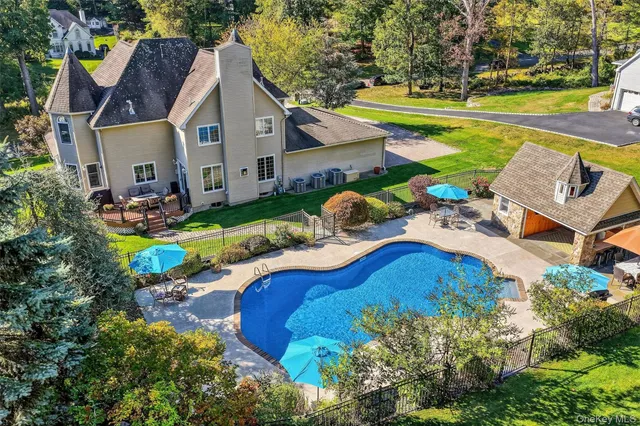 an aerial view of a house with a swimming pool patio and outdoor seating