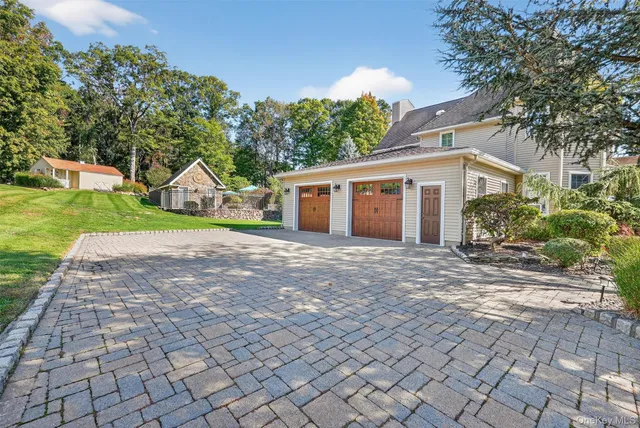 a view of a house with yard and a garden